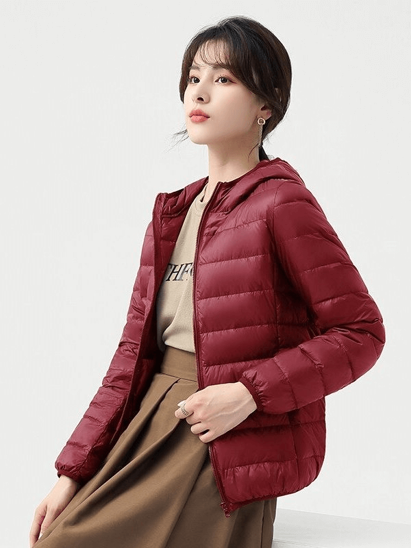 Woman wearing a stylish red down jacket with hood, perfect for outdoor activities, lightweight and warm, model SF0108.